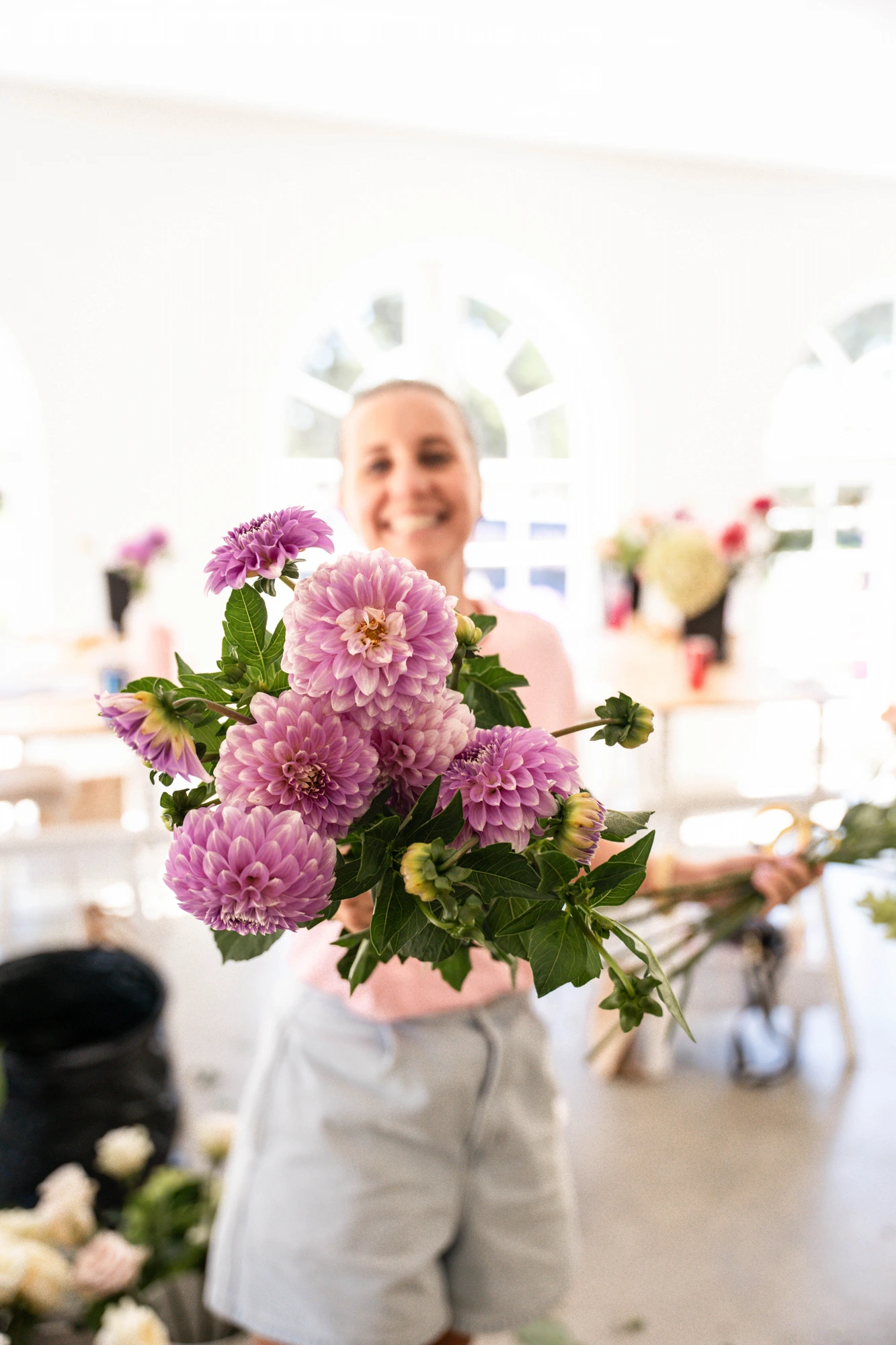 Florist holding a bouquet of dahlias